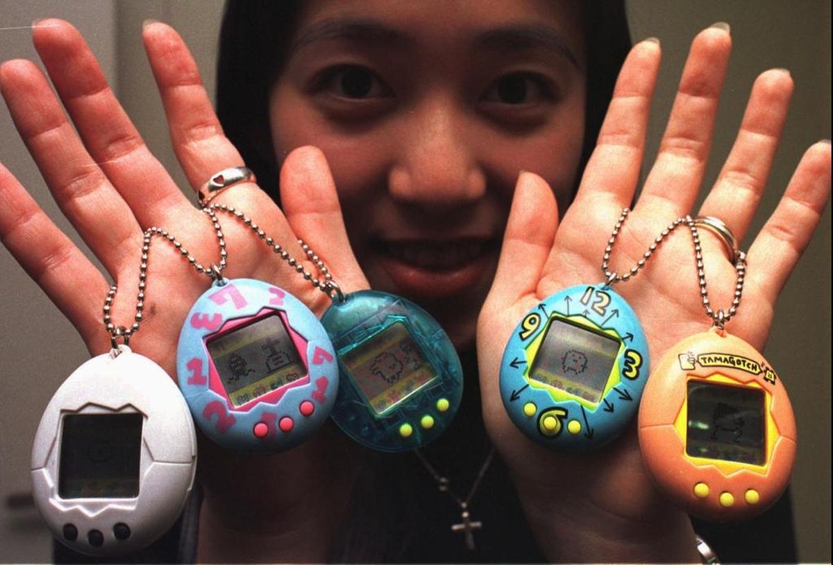 Bandai Co. Ltd. employee Ryoko Tabuchi shows “tamagotchi,” latest hit products of the Japanese toy maker at its Tokyo headquarters Friday, Jan. 24, 1997.