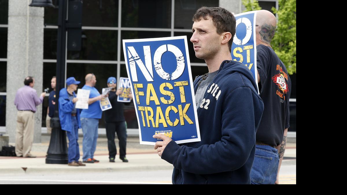 
Josh Hargis of Alton and other protestors were at the downtown Belleville square Monday to speak out against a trade bill by Congress which steelworkers feel hurts their ability to operate in the global steel market. Hargis is a steelworker at GBW Rail Car Services (which repairs steel rail cars) in Wood River and a member of the United Steelworkers union. U.S. Steel plans to temporarily lay off 2080 steelworkers at its plant in Granite City at the end of May. The plant is owned by U.S. Steel which claims inexpensive, foreign steel is flooding the market with steel sold at below market value making it hard to do business. 

