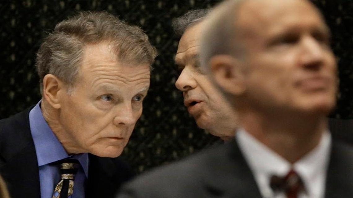 In this file photo, Illinois Speaker of the House Michael Madigan, D-Chicago, left, speaks to Illinois Senate President John Cullerton, D-Chicago, center, while Illinois Gov. Bruce Rauner, right, delivers a budget address.