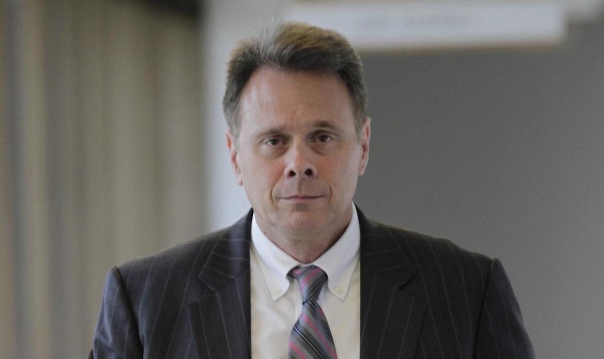 St. Clair County Judge Ron Duebbert walks down the hallway outside the grand jury room on the fifth floor of the St. Clair County Building in July. He had been summoned to appear before the grand jury and was in and out of the room in about 5 minutes.