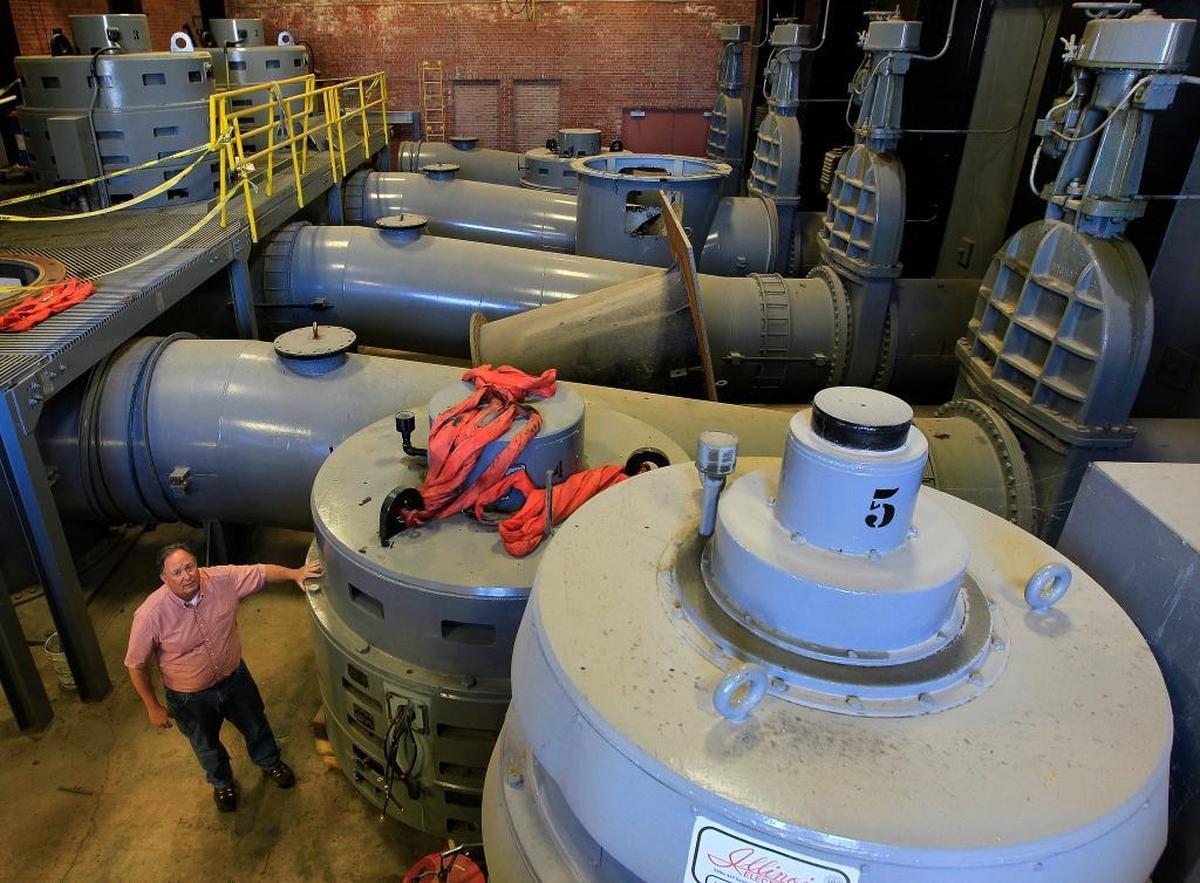Steve Adler is dwarfed by the massive pump motors inside the pumping station where the Cahokia Canal enters the Mississippi River.