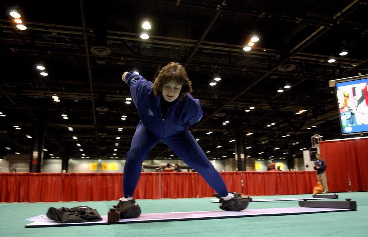 Olympic speed skater Bonnie Blair demonstrates skating techniques on a slide board in Chicago.