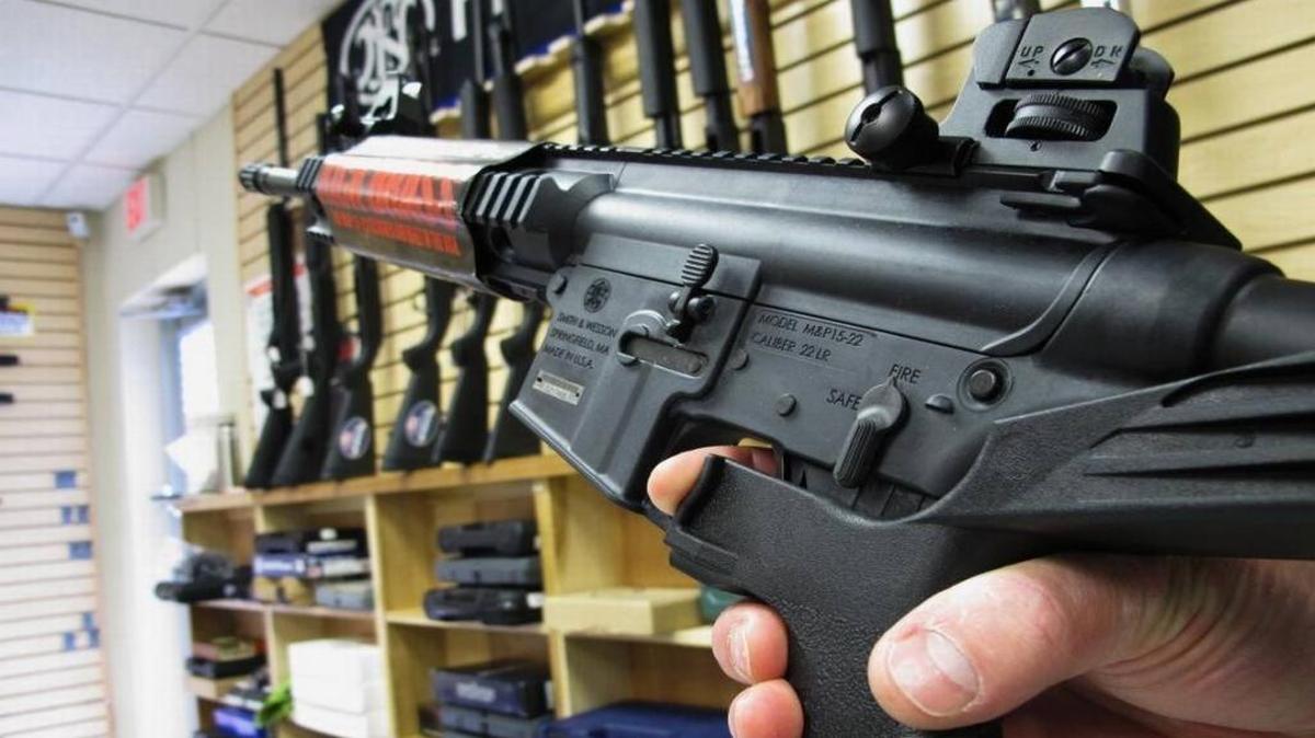 In this file photo, an employee of North Raleigh Guns demonstrates how a “bump” stock works at the Raleigh, N.C., shop.