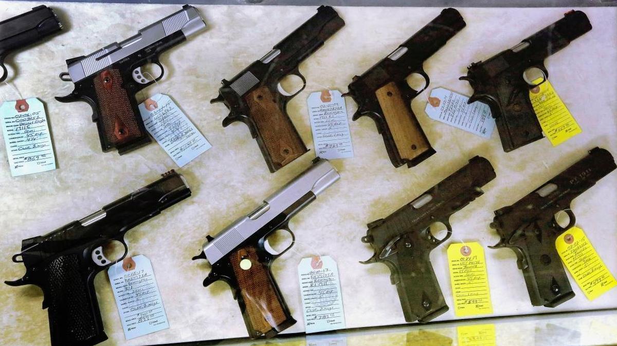 In this file photo, semiautomatic handguns are seen displayed for purchase at an arms supply store in Springfield. Illinois State Police granted far fewer concealed-carry permits statewide in 2015 than in 2014, according to numbers released by the agency. But while the number of granted permits is down, the number of objections to applications that were made by law enforcement has more than doubled.