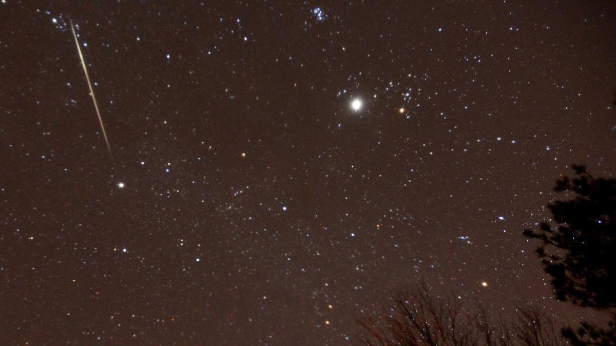 In this file photo, a meteor streaks across the sky during the annual Geminid meteor shower over Springville, Ala. The 2022 Geminids meteor shower will peak Dec. 13 to Dec. 14.