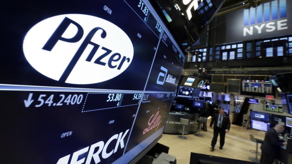 The Pfizer logo appears on a screen above its trading post on the floor of the New York Stock Exchange in this file photo.