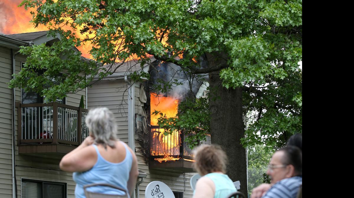 
Residents of St. Clair Village apartments in Belleville watch as a fire rages in an apartment Sunday afternoon. East Side fire department and Swansea fire department responded to the apartment fire located in the St. Clair Village apartments in Belleville with assistance by Belleville Police, St. Clair County Sheriff's department and Abbott EMS. See more photos from the fire at bnd.com.
