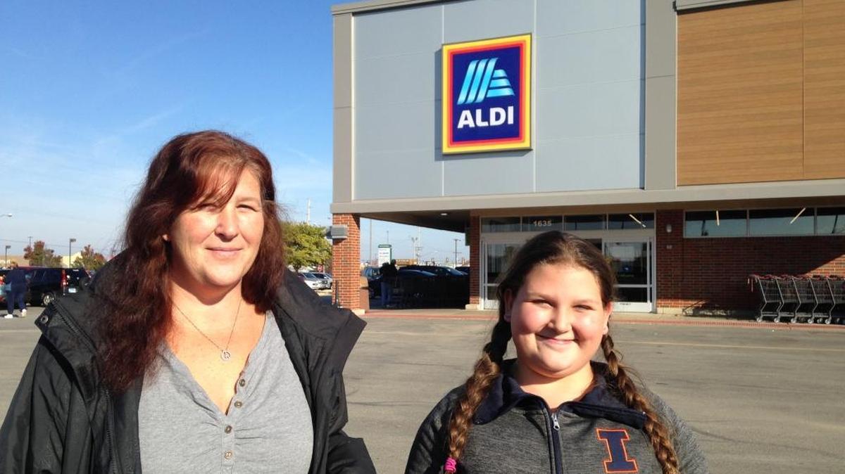 Kindra Bell, left, of Fairview Heights, and her daughter, Maelynn Procasky, 11, were among shoppers at the newly remodeled Aldi store in O’Fallon on Monday.