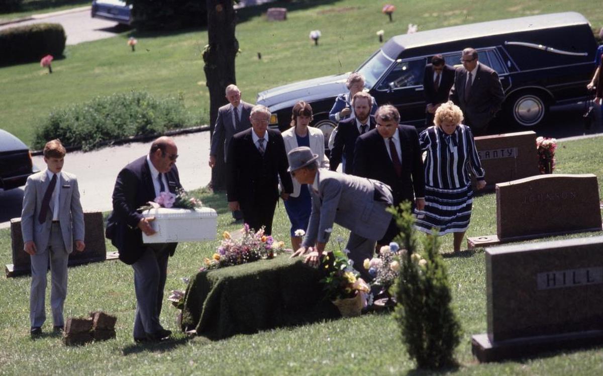Funeral director Dave Smith carries Heather Sims’ casket on May 10, 1989, before she is buried next to her sister, Loralei, in Woodland Hill Cemetery, near Wood River.