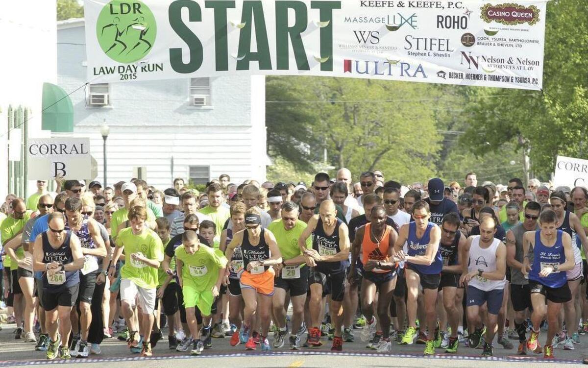 
Runners take off in the annual Law Day Run through downtown Belleville on Saturday morning. The 5K race featured three groups, or corrals, of runners, grouped according to their finishing times in previous races. There was also a wheelchair racer entered in the competition. This is Corral A, comprised of the fastest runners. At far right is the eventual winner, Jon Yoch of Collinsville, who finished with a time of 17:26. He is a member of the St. Louis Track Club. To the left, two racers down the front line, is his friend and training partner, Colby Garman, also of Collinsville, who finished second in the men's division. 
