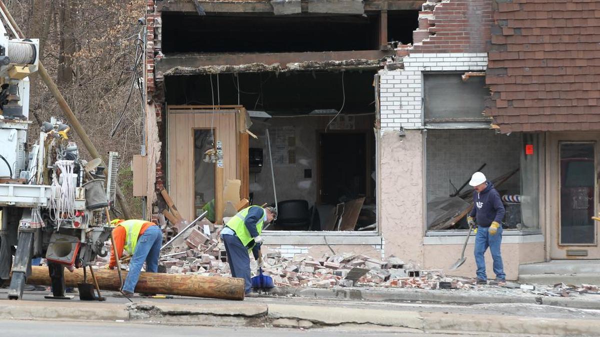 Work crews replace a utility pole and clean up debris after an early morning vehicle collision. According to reports a sedan could be seen with its front end driven through the front window of the one-story office in the 10600 block of West Main Street, near Illinois 157 in Belleville. A power pole fell across the trunk of the car during the crash.