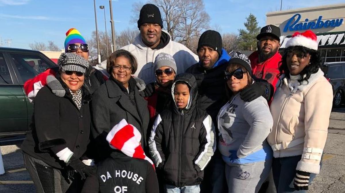 April Jenkins squats to show the name of the organization that organized the event — Da House of Ooh Wee. Others, from left, include Revonne Pleasant, St. Clair County Circuit Judge Zina Cruse, Dwanyetta Brazil, East St. Louis City Councilman Robert Eastern, Carmel Latte, James Jones, Tina Ivory, Lawrence Brazil and Terry “T-Baby” Jenkins.