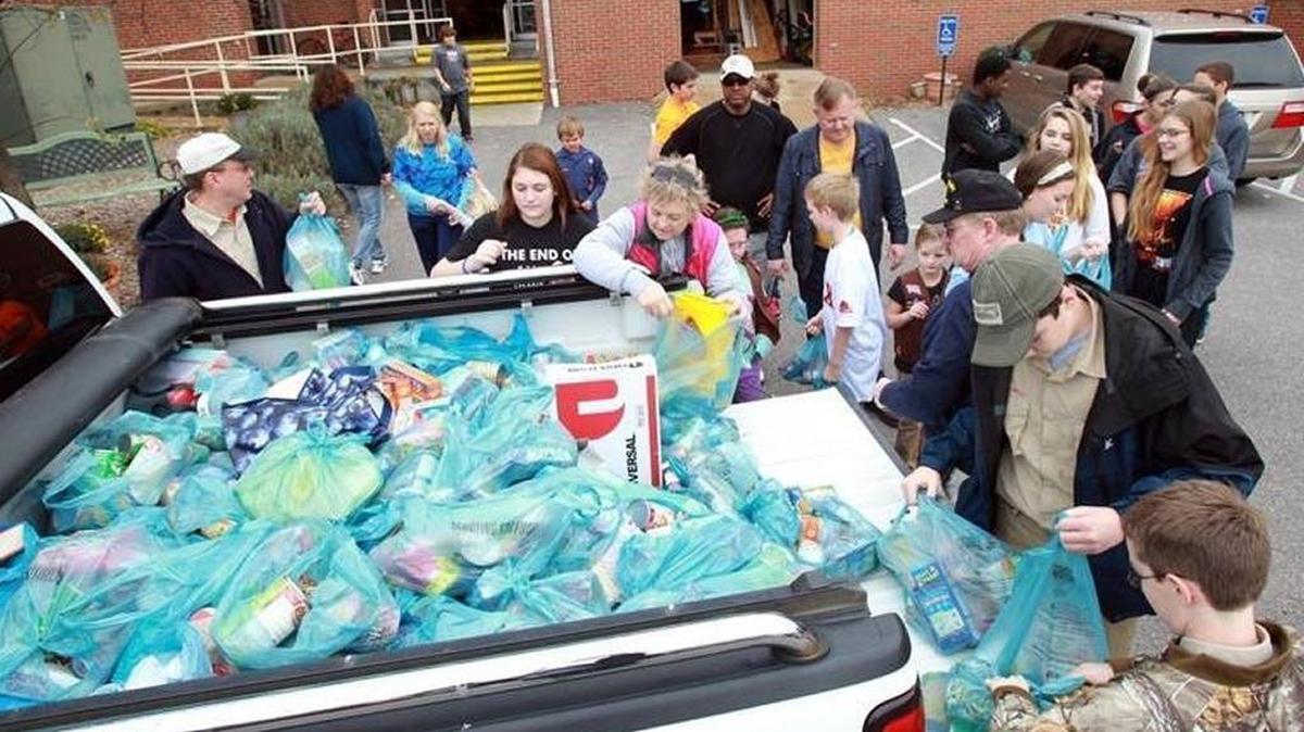 In this BND file photo from Nov. 16, 2013, volunteers help unload a truck of donations to Scouting for Food. Started in 1985, the annual food drive collects approximately two million items that serves approximately 500 pantries within the Greater St. Louis Area Council.
