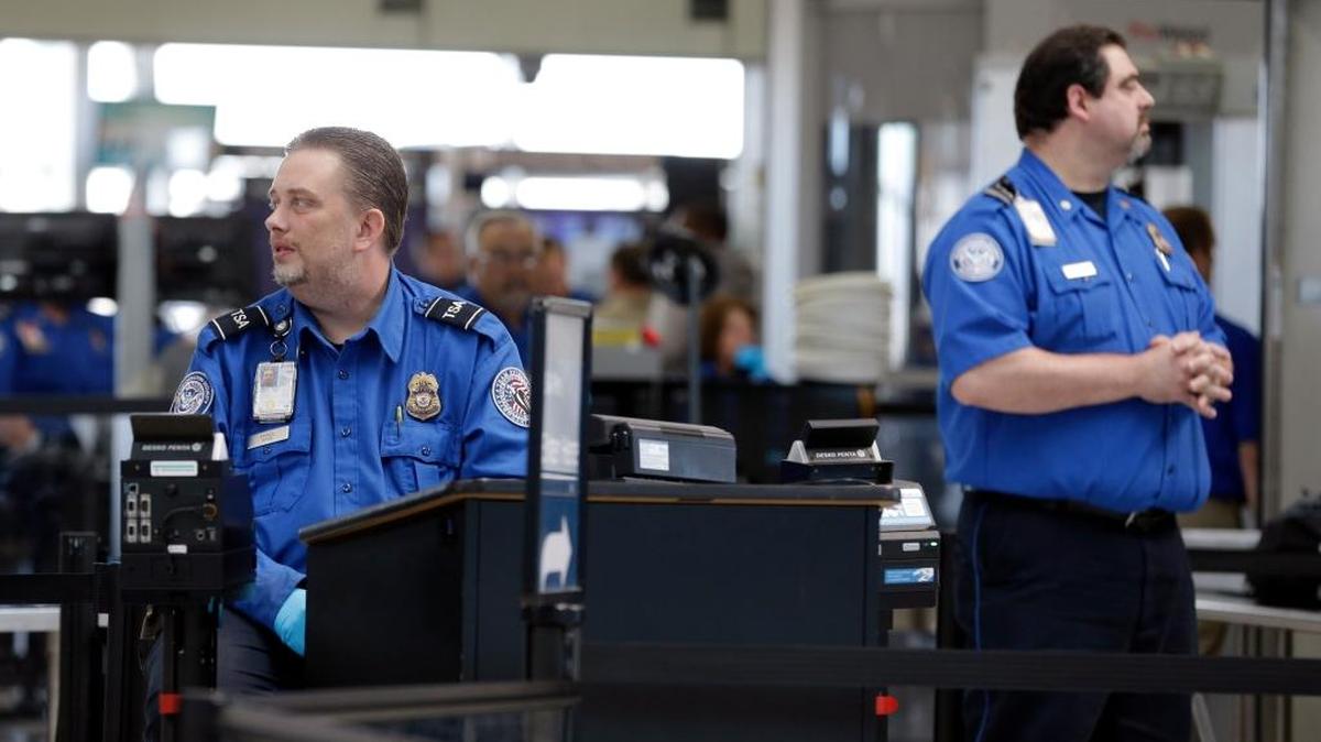 In this AP file photo from April 12, 2016, Transportation Security Administration inspectors monitor a security checkpoint at Lambert-St. Louis International Airport in St. Louis.