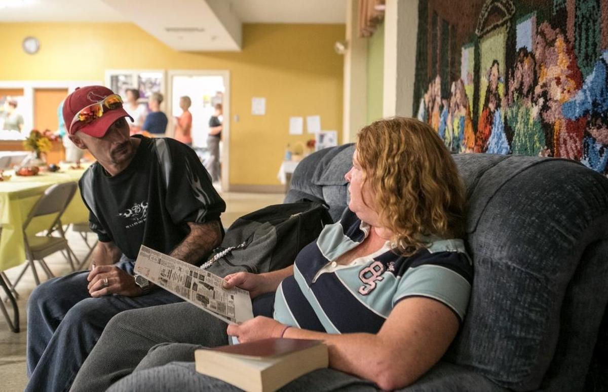 Dennis Dixon and Janie Medford talk about a job listing during a lunch sponsored by Beacon Ministry. Tragic life events brought Janie Medford and Dennis Dixon together now they are expecting twins.