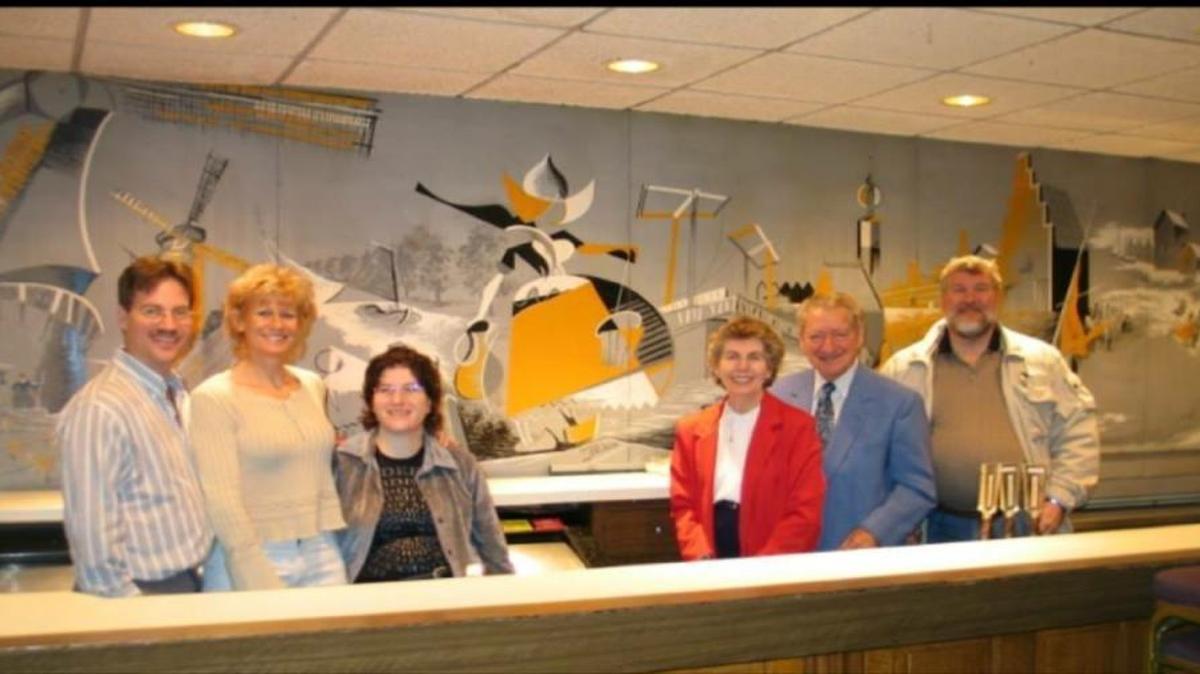 Here is a photo of Oelrich family members in front of painting by Harvey Oelrich. From left, Larry Oelrich, Nancy Oelrich, Eileen Oelrich Hoag, Marie Oelrich, Chuck Oelrich, Jerome Oelrich. “We were always so proud of this painting. Barb (Fischer) Laidlaw, a classmate of mine at Belleville East, told me years later how she used to sit & watch my uncle paint it. It was a ritual for us to show friends that painting.”