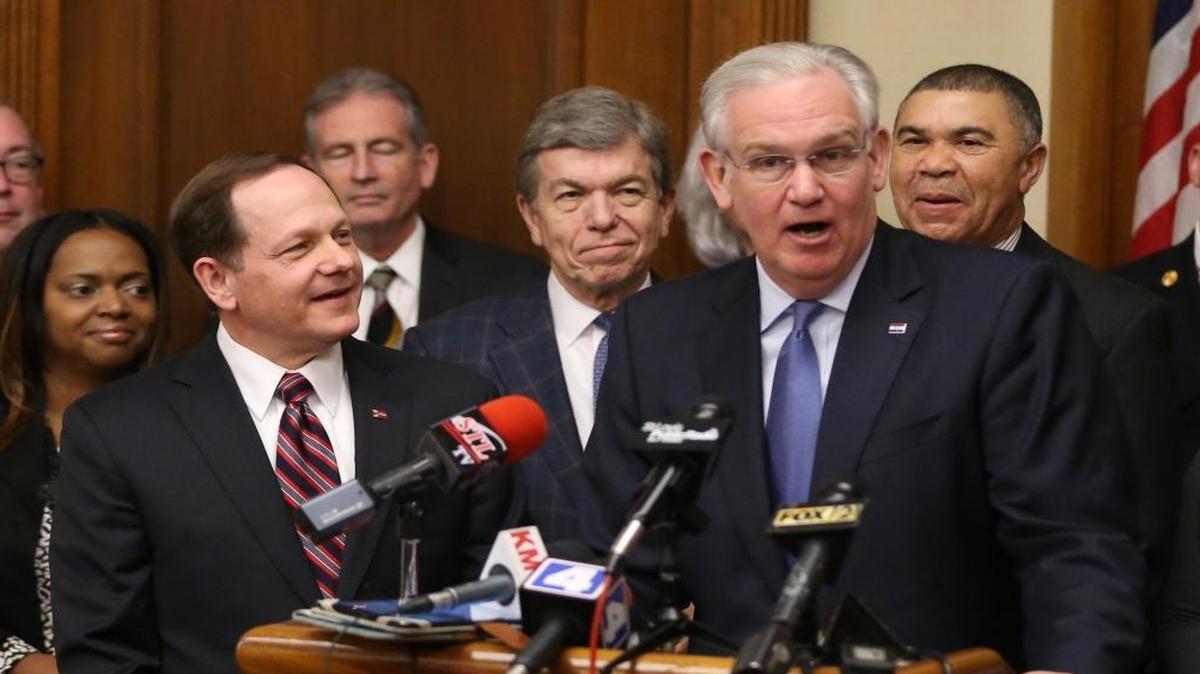 St. Louis Mayor Francis Slay, left, and Missouri Gov. Jay Nixon, right, discuss the benefits of a St. Louis site for the new western headquarters of the National Geospatial-Intelligence Agency.