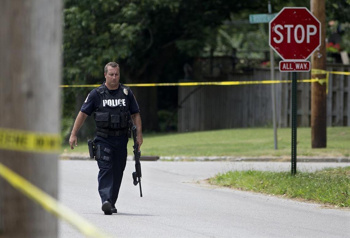 A Belleville police officer walks on S. 20th St. with his assault rifle July 4, 2017.