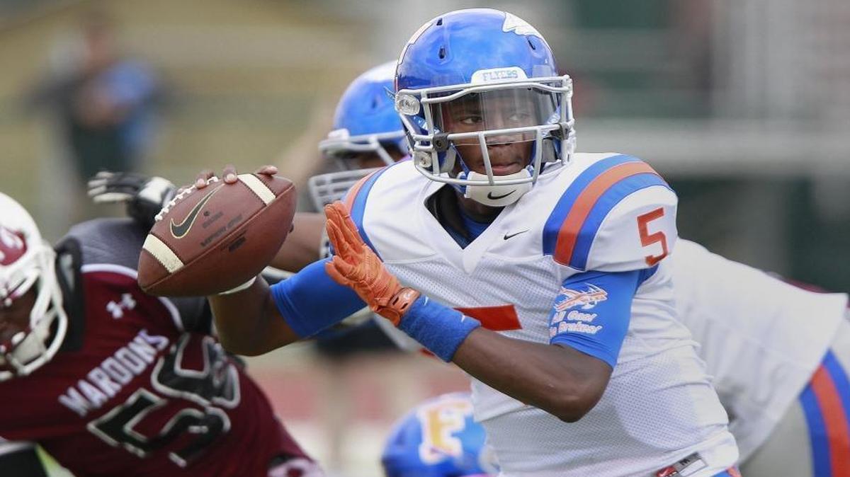East St. Louis quarterback Reyondus Estes looks downfield for a receiver during an early-season game against Belleville West.