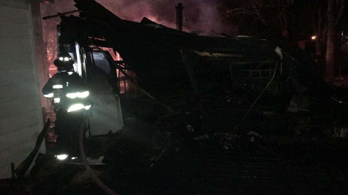 Firefighters battle the fire early Wednesday in the detached garage at 415 N. 39th St.