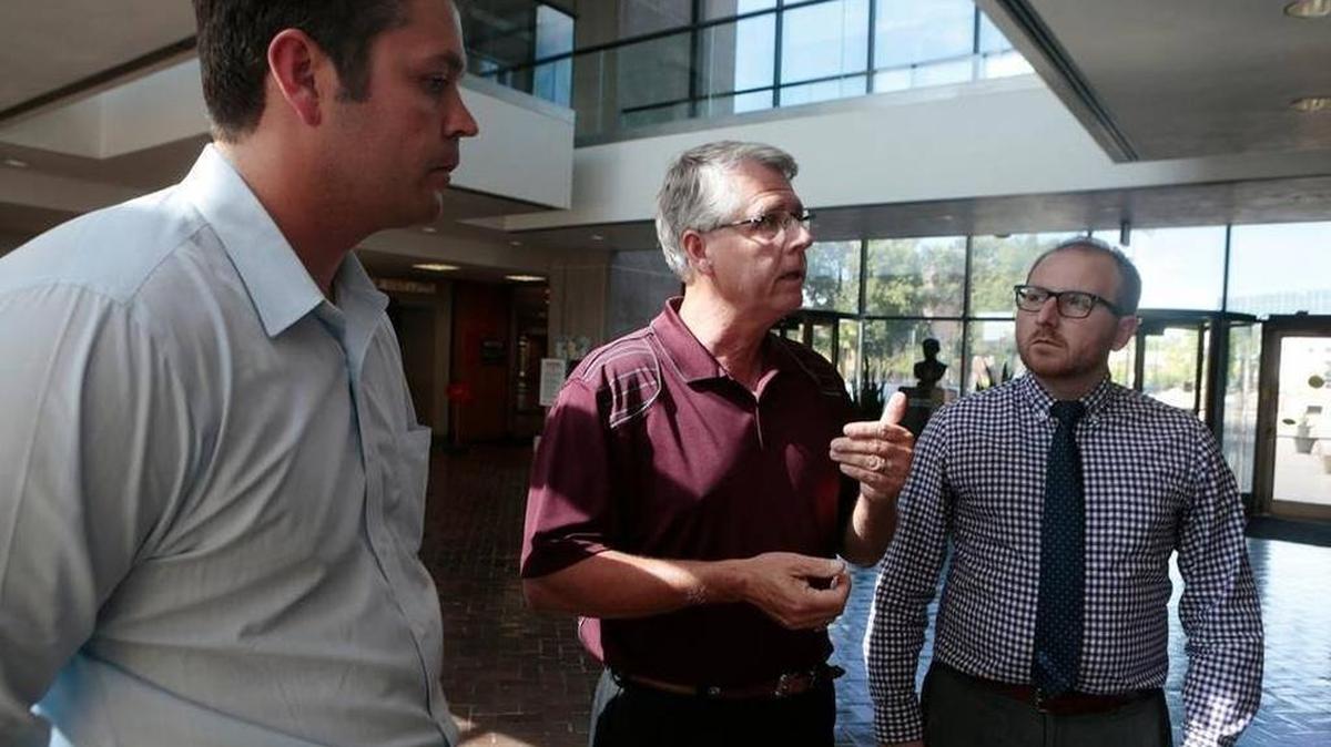 From left: Attorneys John Hipskind, and far right, Brady McAninch of Hipskind & McAninch, LLC., and St. Clair Township Highway Commissioner, John “Skip” Kernan (center) talk to a reporter about the lawsuit related to the controversial sewer services contract between St. Clair Township and Swansea. File Photo - June 5, 2015