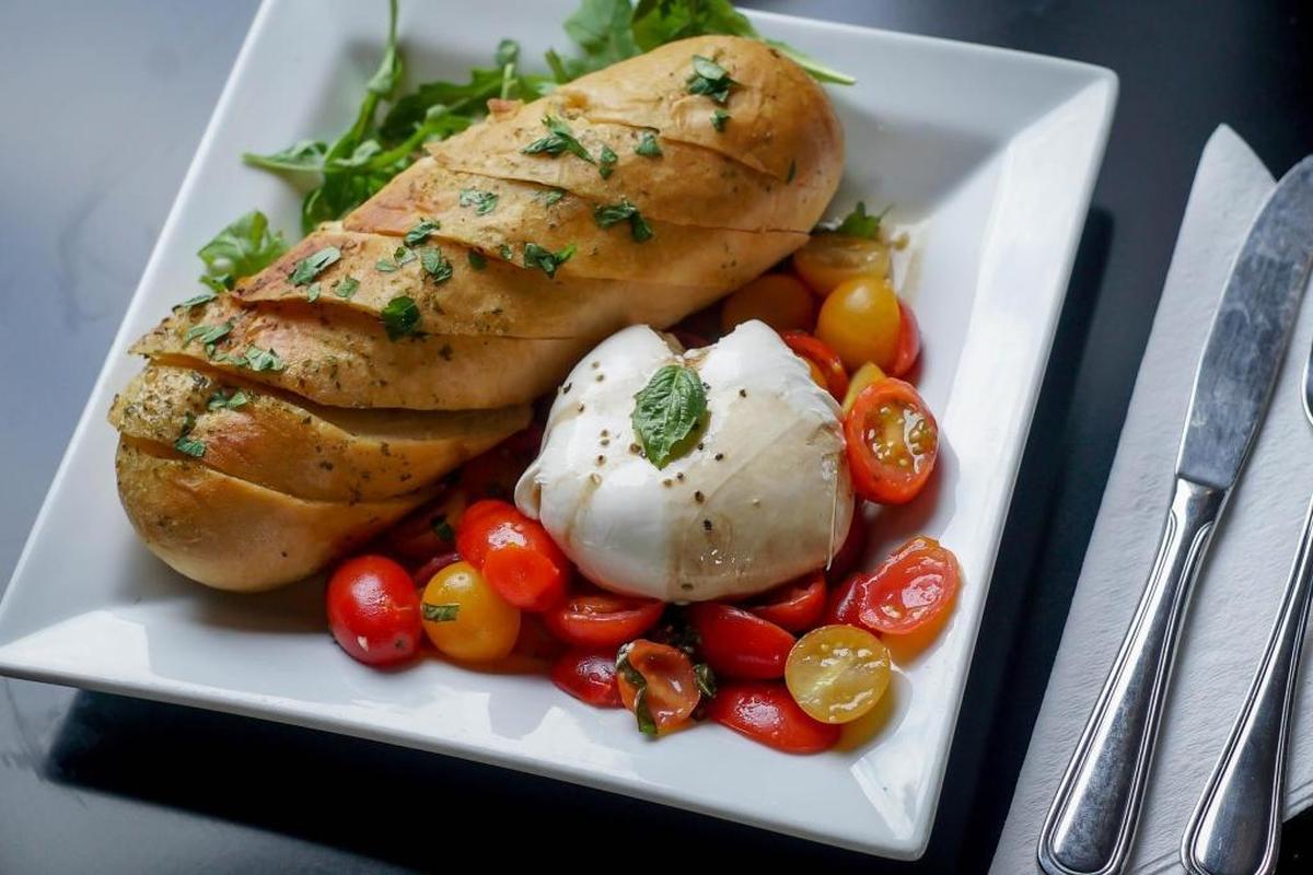 Seven Belleville has a new menu. A look at the creamy burrata served over a bed of halved cherry tomatoes, basil, and garlic drizzled with olive oil and balsamic. Served with a crusty baguette.