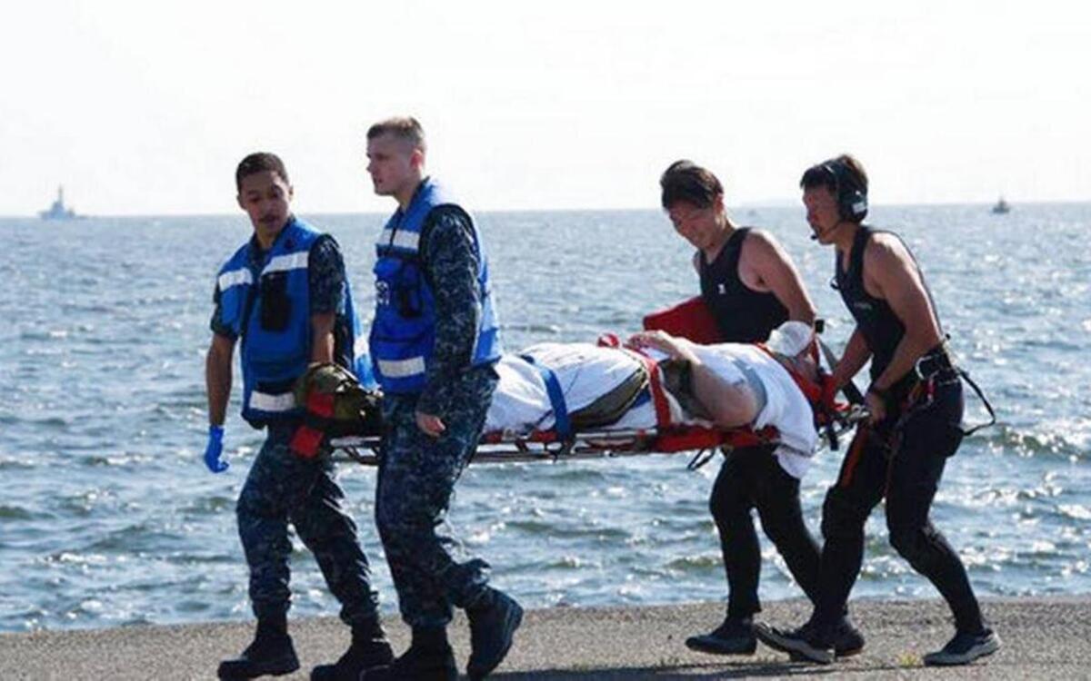 In this photo released by Japan’s Defense Ministry, an injured USS Fitzgerald personnel is carried by U.S. military personnel, left, and Japanese Maritime Self-Defense Force members upon arriving to the U.S. Naval base in Yokosuka, southwest of Tokyo, after the U.S. destroyer collided with the Philippine-registered container ship ACX Crystal in the waters off the Izu Peninsula on Saturday, June 17.