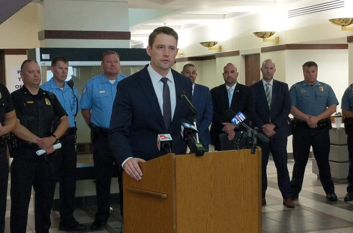 The office of Madison County State’s Attorney Tom Haine, shown speaking at an unrelated news conference on Thursday, is prosecuting the criminal case against Kyle Swanson.