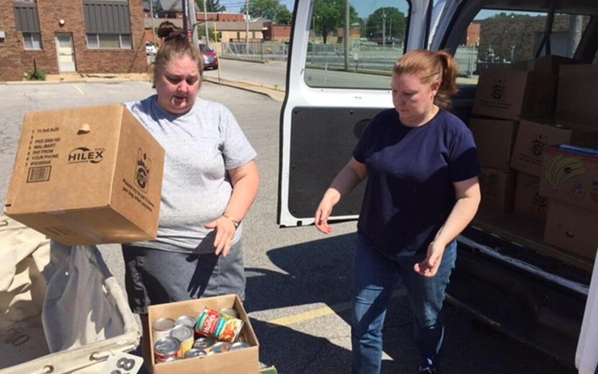 Emma Anna, left, a volunteer with the Faith Baptist Church food pantry in Belleville, and her sister, Valerie Schobert, pick up food delivered to the downtown Belleville Post Office as part of the postal carriers’ 25th annual Stamp Out Hunger food drive on Saturday.