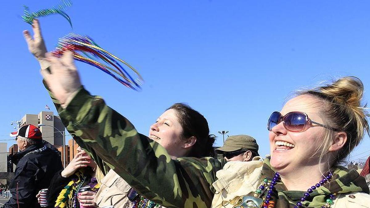 Becky Schulte, from Belleville, and Michele Glauber, from Millstadt, threw some of the 20,000 beads on board Crehan’s Irish Pub’s “SS Belleville” on Saturday during the Mardi Gras parade. Look below for 360-degree video from atop the float.