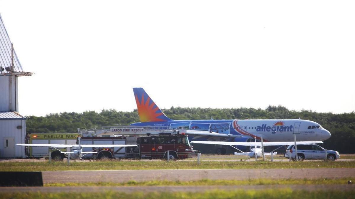 An Allegiant Airbus jet lands safely at St. Petersburg-Clearwater International Airport recently after the pilot reported problems. Emergency vehicles wait nearby next to the north south runway.