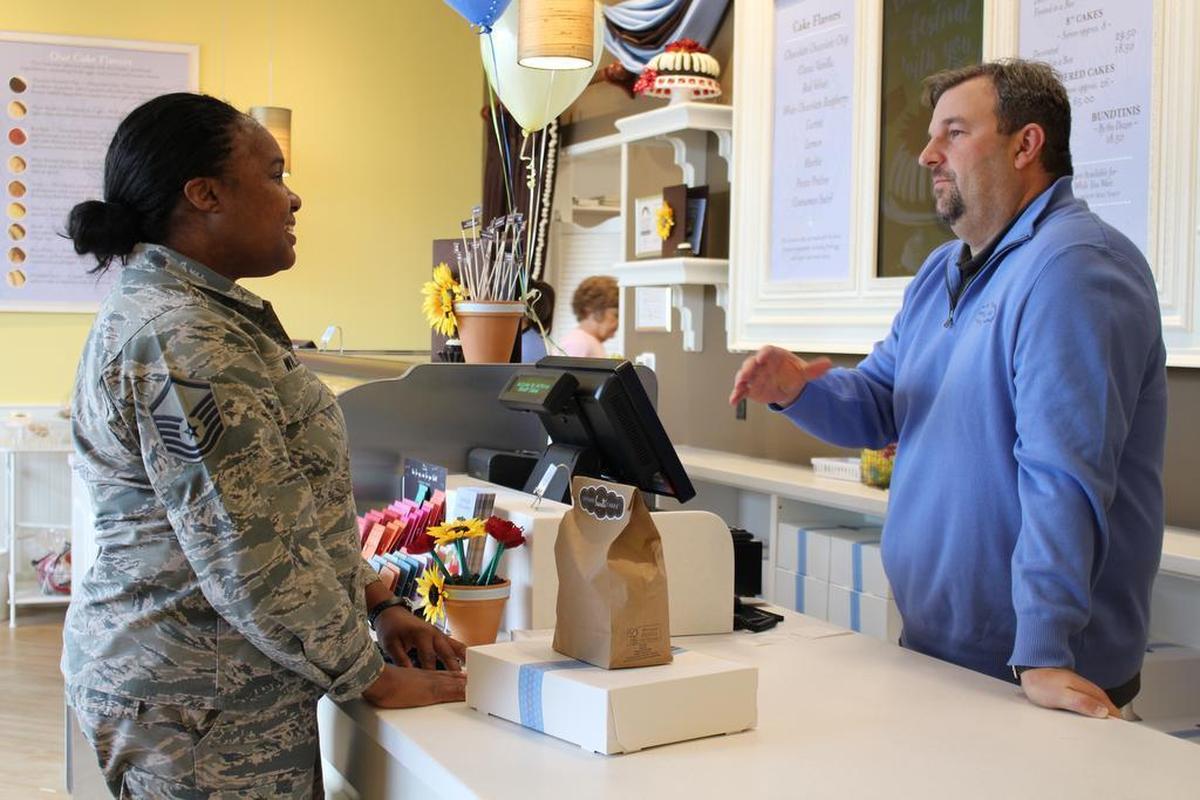 Owner Aaron Fricke, right, chats with customer Dawn Williams at the new Nothing Bundt Cakes store in Fairview Heights.