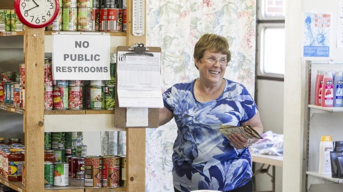 All items collected during the Kassly Mortuary food drive will be delivered to the Fairview Heights Food Pantry and Catholic Urban Program. Pictured: JoAnn Nadler smiles at a client as she helps select their food at the Fairview Heights Area Food Pantry.