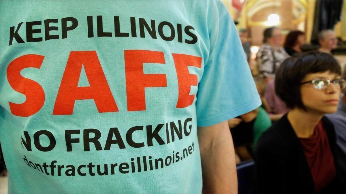 In this 2013 file photo, a protester attends a rally after a House committee hearing on “fracking” legislation at the state Capitol in Springfield. The oil and gas drilling technique is off to a feeble start across Illinois as slumping oil prices and the rigors of Illinois’ new regulations have energy interests cautiously waiting on the sidelines.
