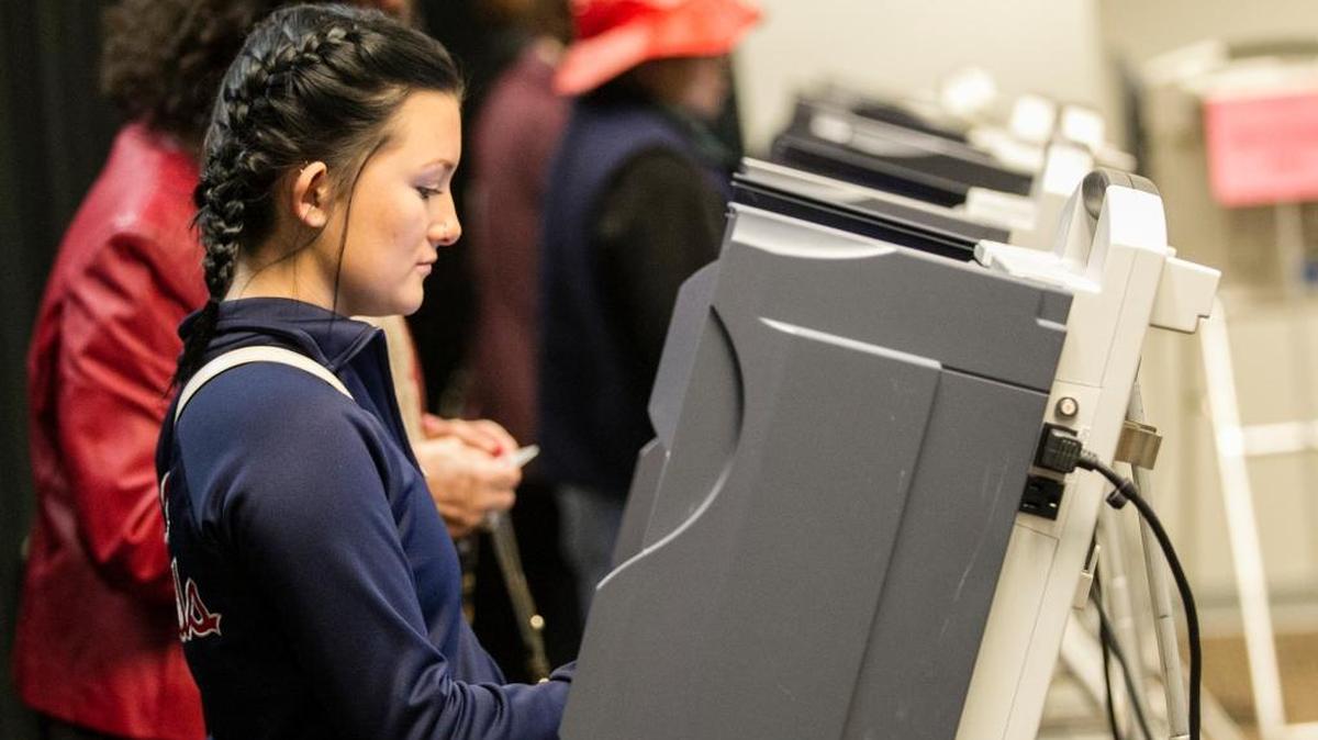 First-time voter Taylor Dowling, 20, of Swansea and other voters take advantage of early voting at the St. Clair County Clerk's office Monday.
