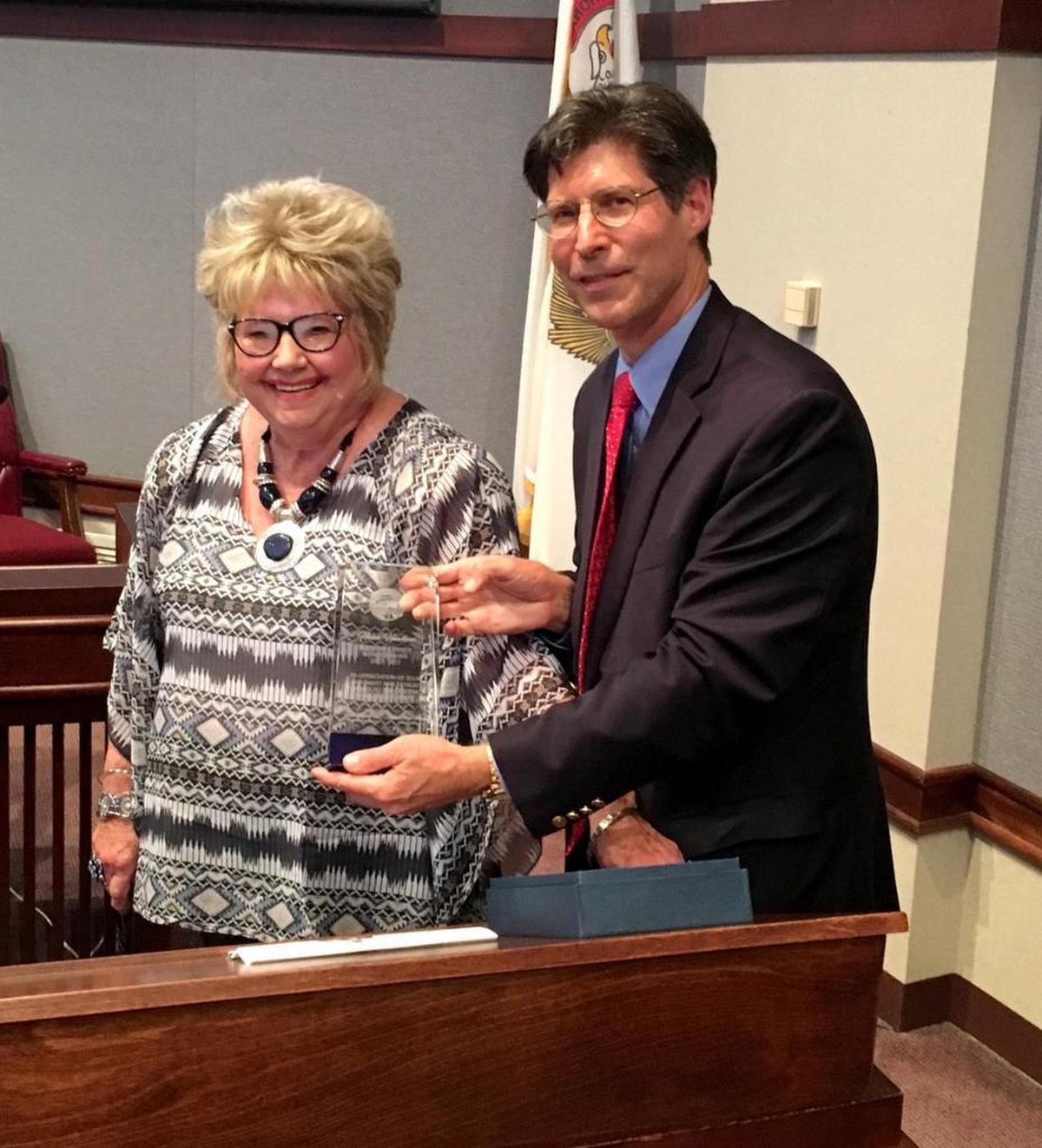 Helen Hawkins receives an Outstanding Service Award at a regular meeting of the Madison County Board.