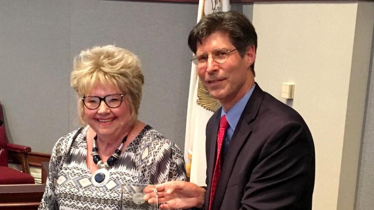 Helen Hawkins receives an Outstanding Service Award at a regular meeting of the Madison County Board.