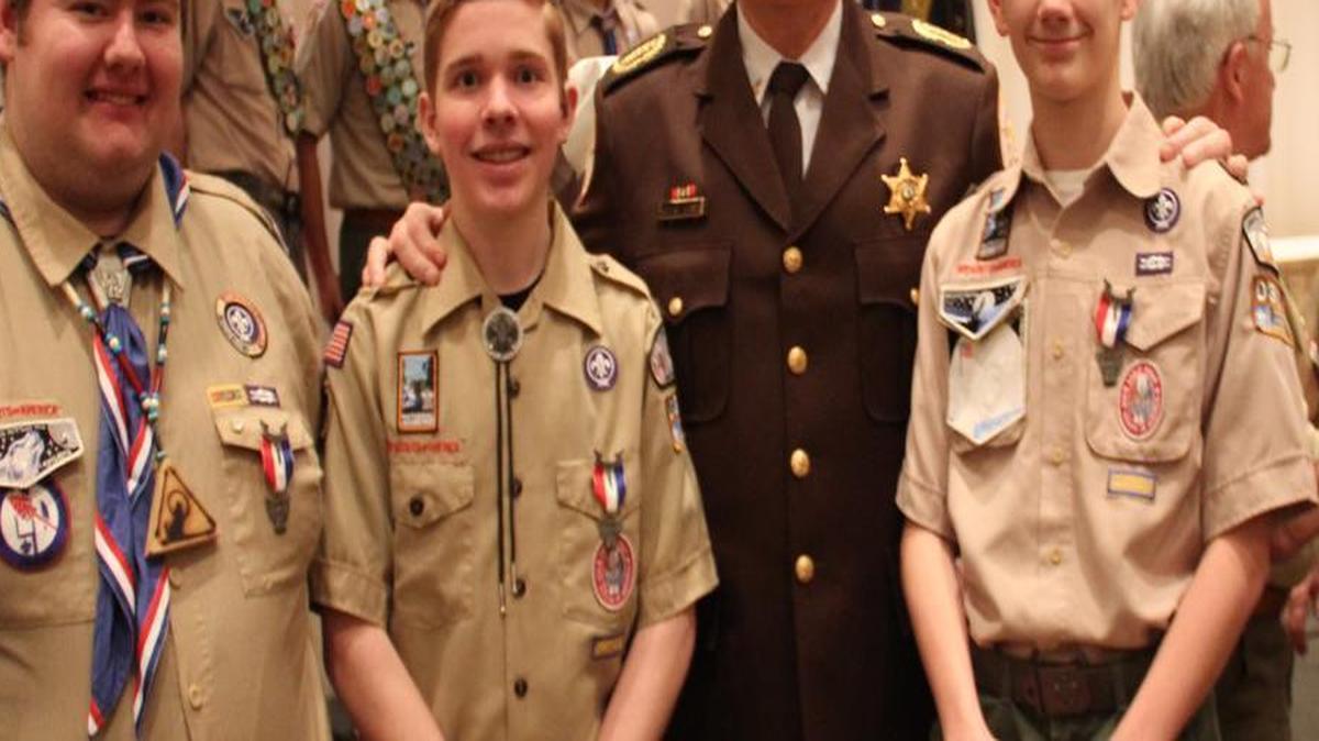 Eagle Scouts, from left, William Lanman, Jacob Noll and Camden Westfall pose for a photo with St. Clair County Sheriff Rick Watson.