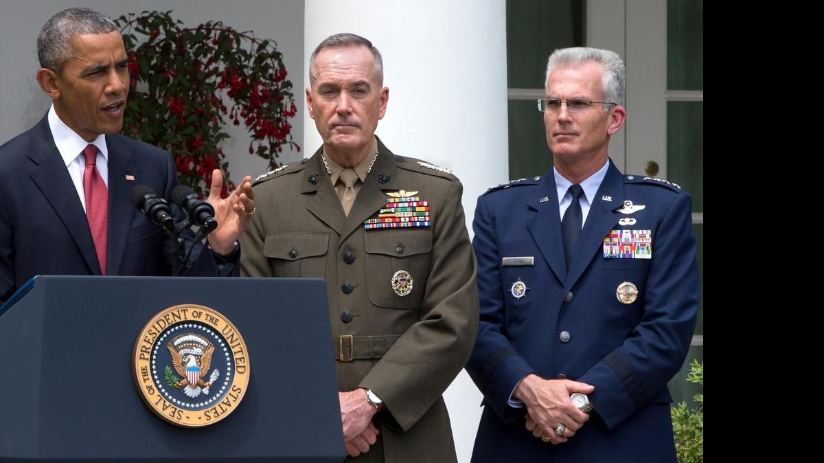 
Marine Gen. Joseph Dunford Jr., center, with Air Force Gen. Paul Selva, listens as President Barack Obama announces that he will nominate Dunford as the next chairman of the Joint Chiefs of Staff, and Selva as the vice chairman, Tuesday, May 5, in the Rose Garden of the White House in Washington. Obama chose Dunford, a widely respected, combat-hardened commander who led the Afghanistan war coalition during a key transitional period during 2013-2014, to succeed Army Gen. Martin Dempsey. 

