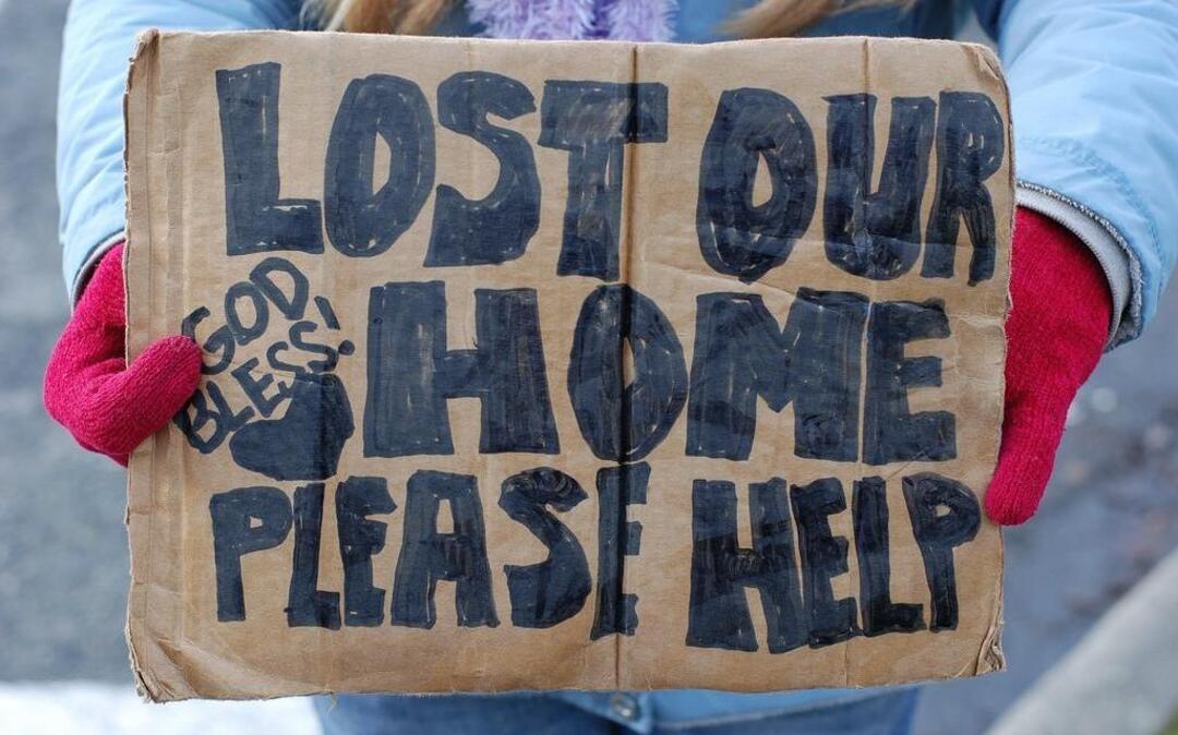 A panhandler holds a sign in Kirkland, Washington, on Nov. 28, 2010.