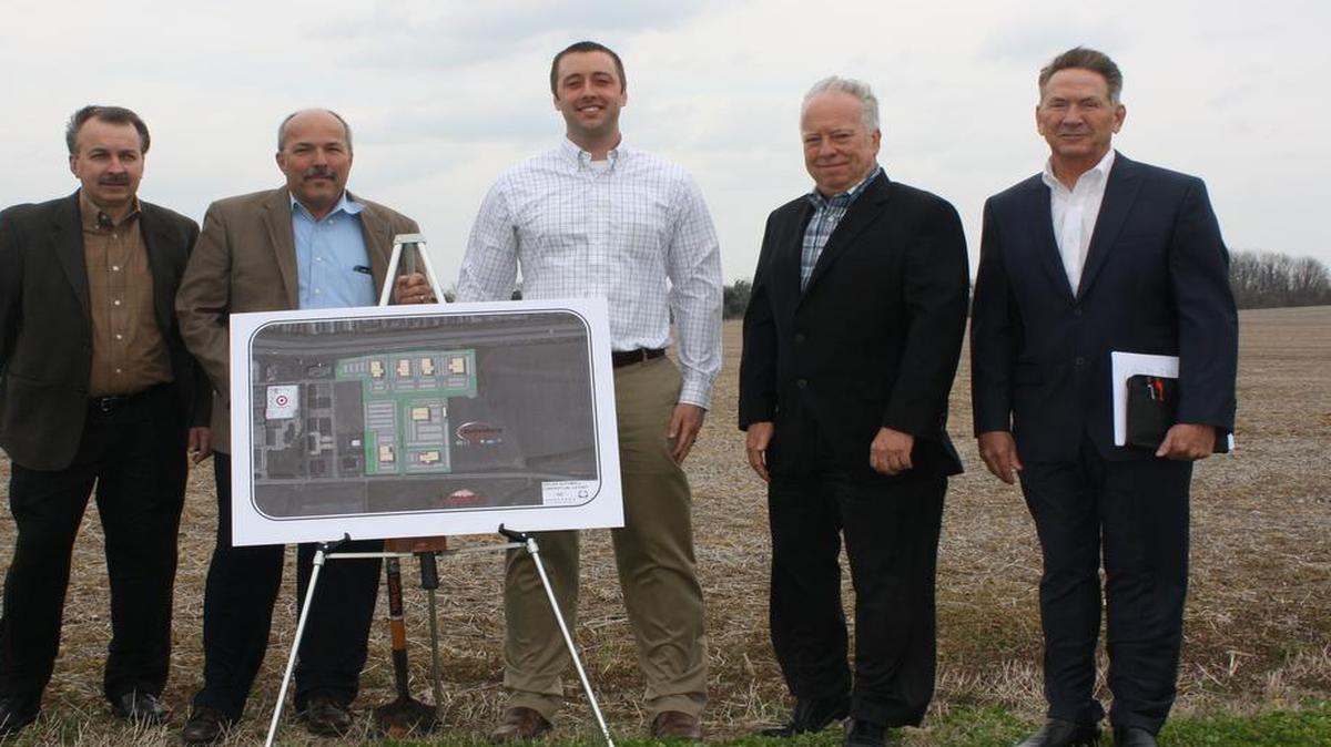 From left, Shiloh Trustee Bob Weilmuenster; Mayor Jim Vernier; Mike Auffenberg; James Auffenberg, Jr., and, Terry Johnson of Barber Murphy Group Inc., stand next to the 36 acres on Frank Scott Parkway in Shiloh where the Auffenberg Dealer Group will relocate.