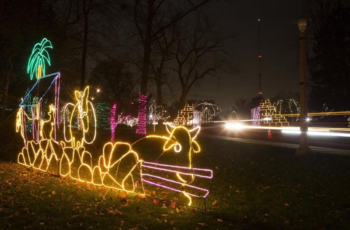 Cars streak by a lighted display at the Annual Way of Lights Shrine of Our Lady of the Snows.