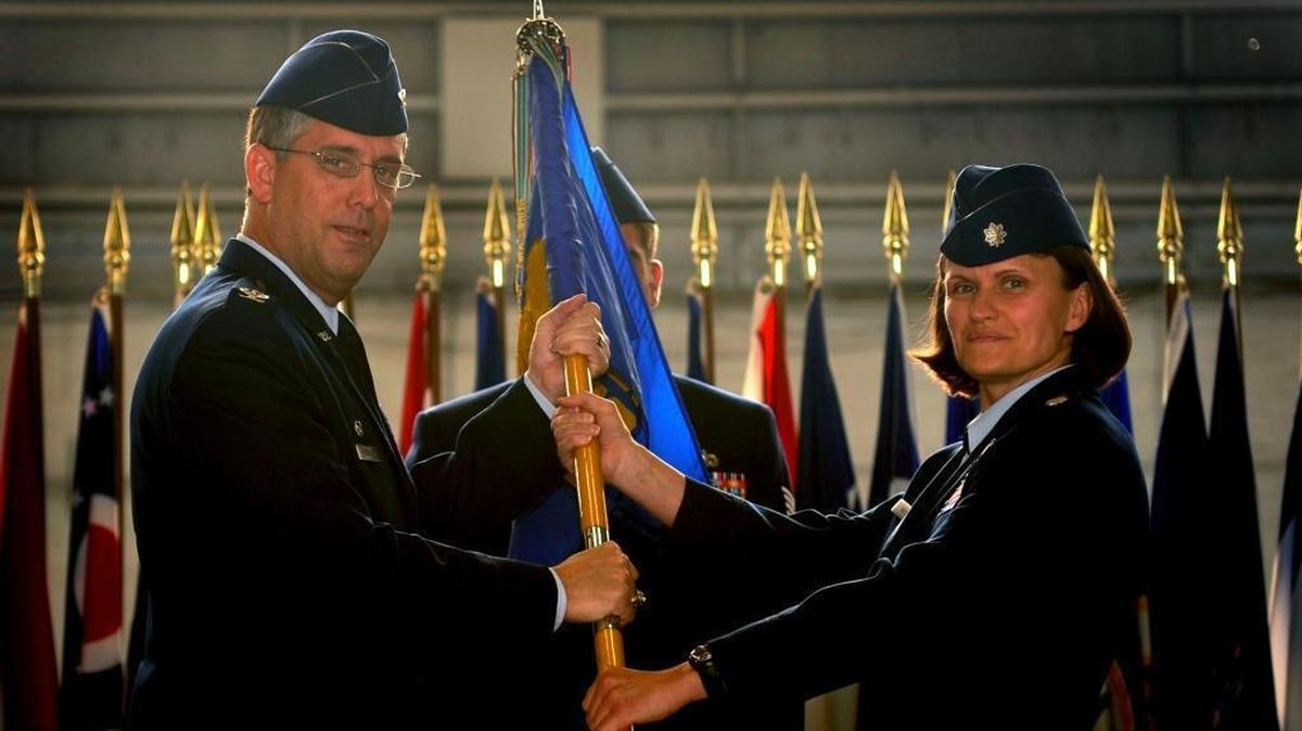 Col. James Morgan, 6th Operations Group commander, hands the 6th Operations Support Squadron’s unit flag to Lt. Col. Leslie Maher during a change of command ceremony at MacDill Air Force Base, Fla., on April 29, 2011.