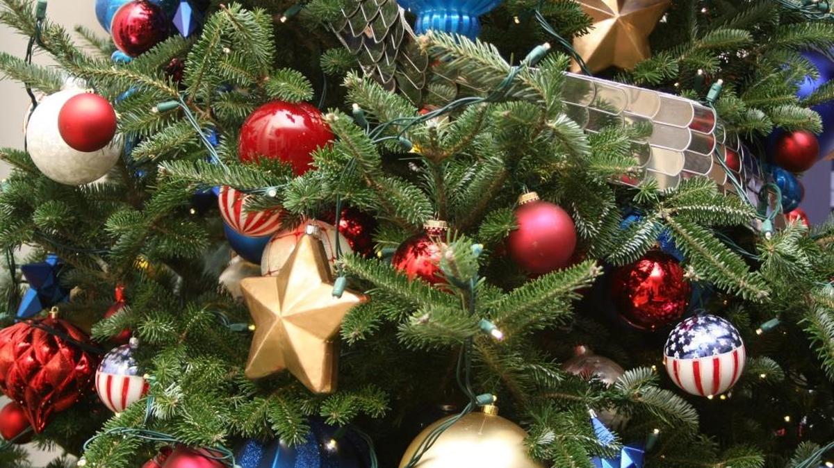 A Christmas tree in the White House is decorated with gold ornaments to honor service members who have made the ultimate sacrifice for the United States.