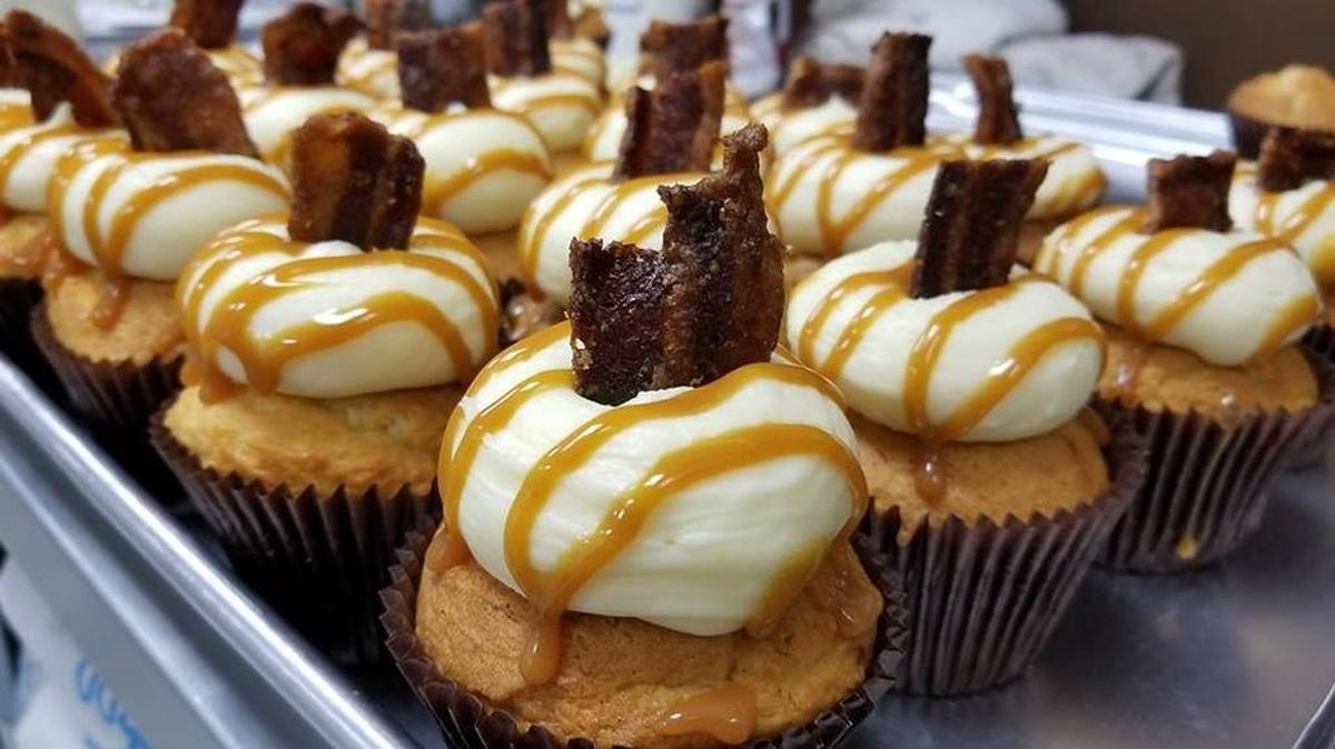 The Candied Pig at Smallcakes of Fairview Heights. Vanilla Cake topped with cream cheese and then a caramel drizzle and a nice piece of candied Bacon.