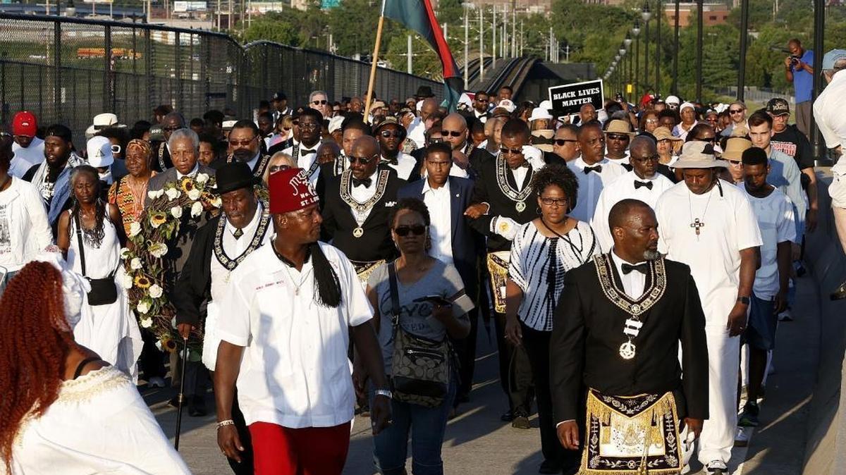 In this July photo, marchers make their way to the mid-point of Eads Bridge as part of the remembrance of the 1917 race riots in East St. Louis.
