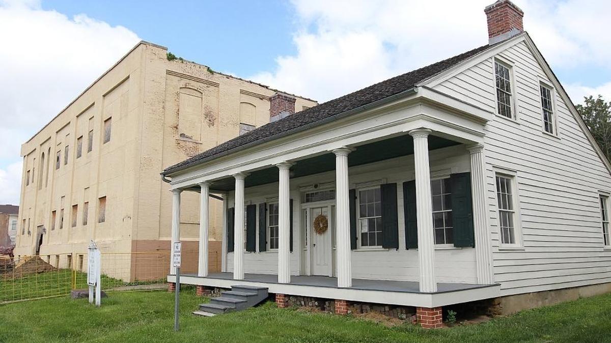 The Collins House (at right) would be moved a few hundred feet into the new area being cleared by demolishing the Main Square Apartments (at left) and Martha Manning Warehouse. The demolition of the apartments and warehouse was happening Tuesday, June 2, 2015, in Collinsville.