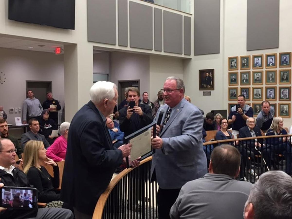 Bob Goalby, left, receives a proclamation from Belleville Mayor Mark Eckert Monday night. Goalby, who won the 1968 Masters and graduated from Belleville Township High School in 1947, was lauded for his service to the community.