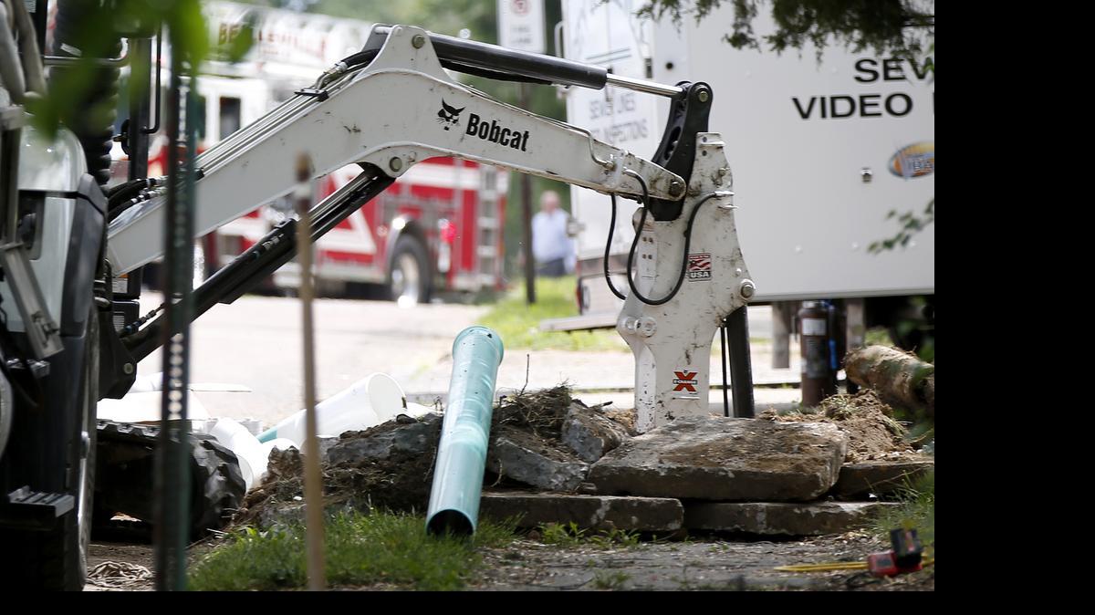 
The digging arm of a Bobcat excavator is shown with part of it under the sidewalk of the home Thursday afternoon on South Charles Street in Belleville.
