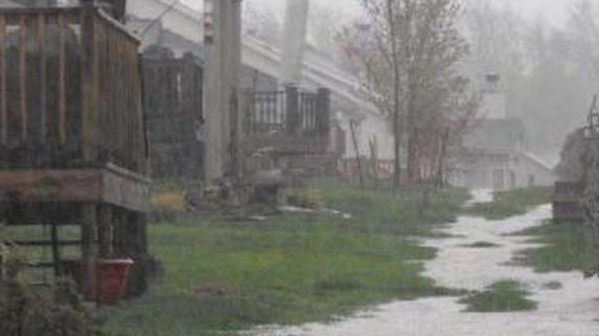 
A photo from a drainage study at The Orchards in Belleville shows rainwater filling a swale behind homes.
